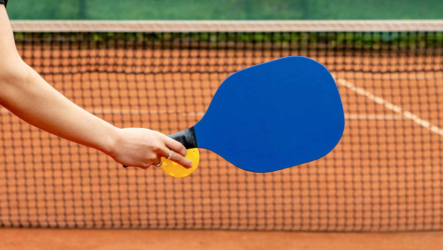 Woman holding pickleball racquet