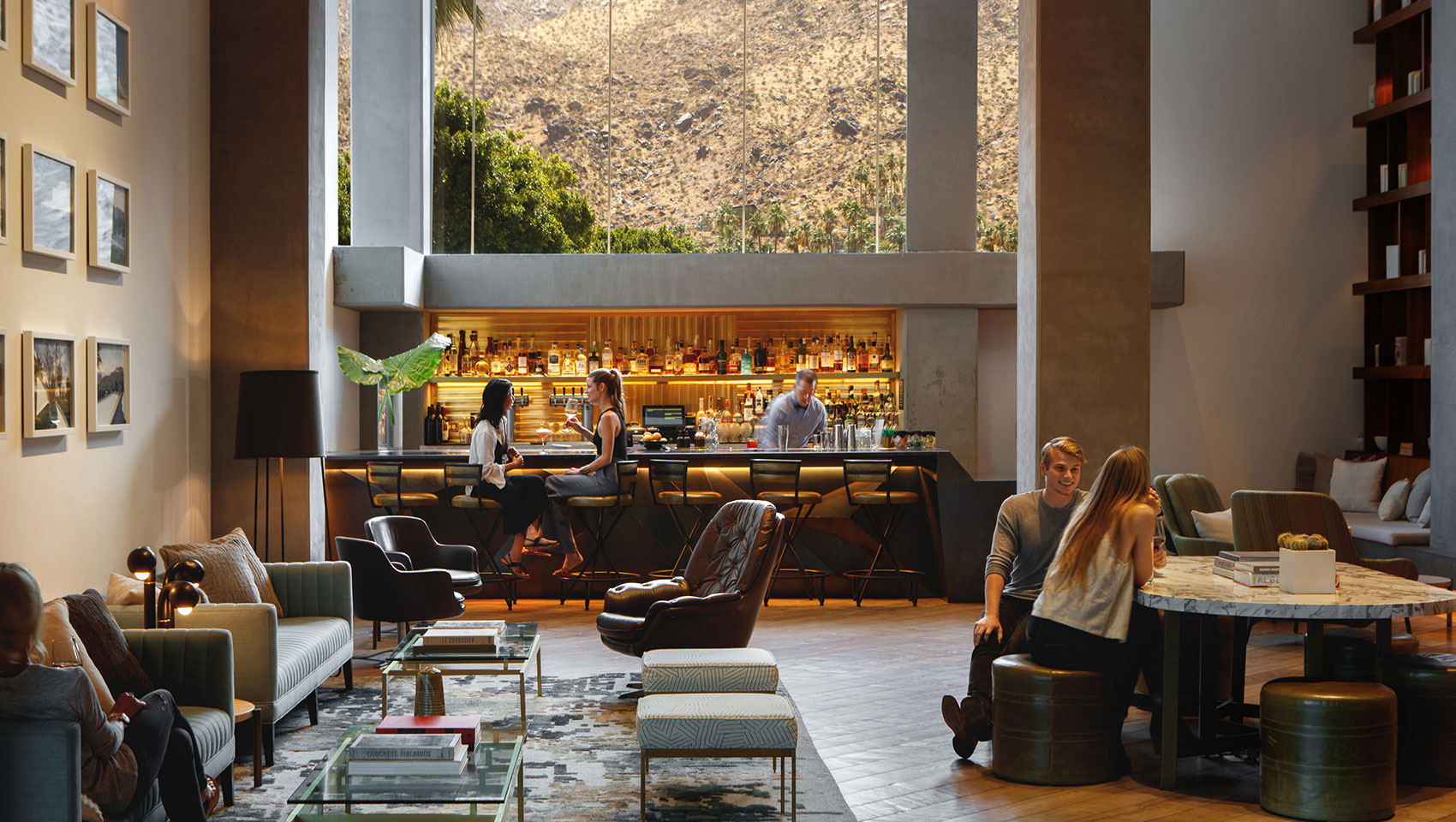 Guests at Kimpton Rowan Palm Springs hotel lobby bar